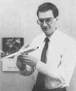Apart from taking and trading photos of airplanes, Henry Tenby has also amassed a large collection of airplane models, and is seen here admiring an NWT Air Hercules in his Yellowknife office.