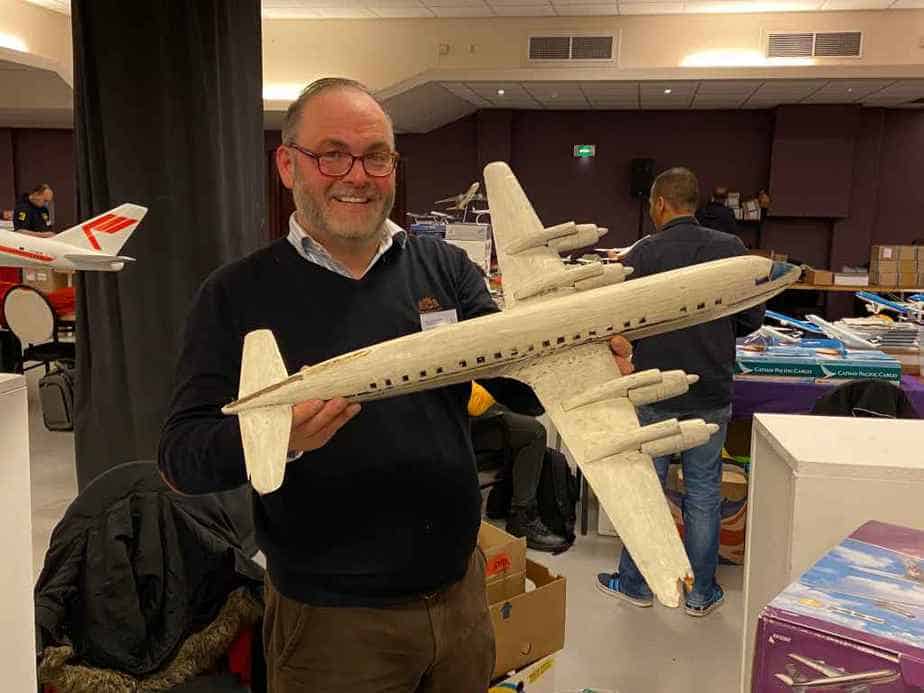 Peter Casell with his wooden 1/50 DC-7 model, in need of serious restoration.